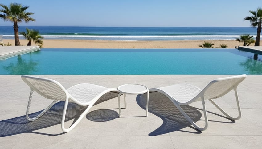 White pool lounge chairs by the ocean
